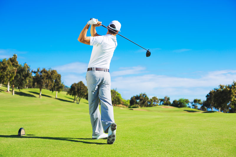 Man golfing with personalized golf balls