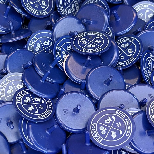 Blue plastic custom golf ball markers featuring a white club logo