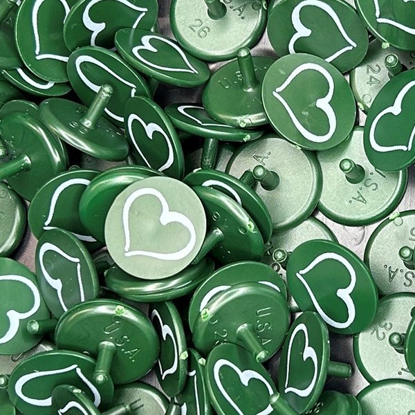 Green bulk golf ball markers featuring a white heart design