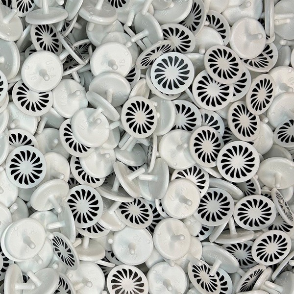 White custom golf ball markers printed with a black sunburst design