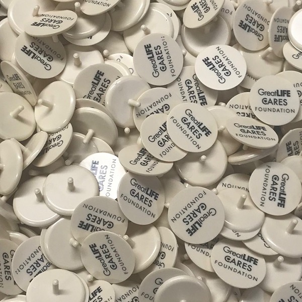 Custom ball markers printed with black company names and branding