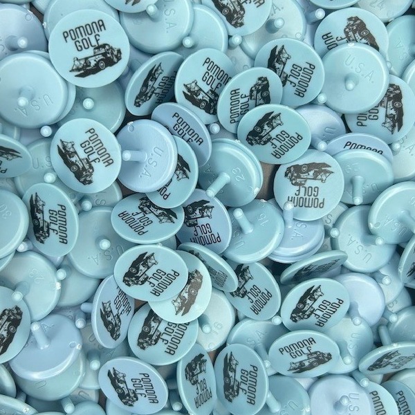 Light blue custom golf markers printed with a black logo