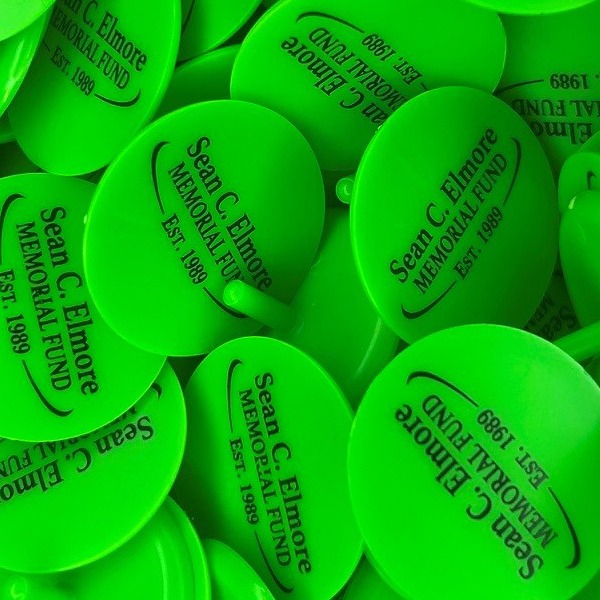 Green personalized golf markers printed for a memorial fund event