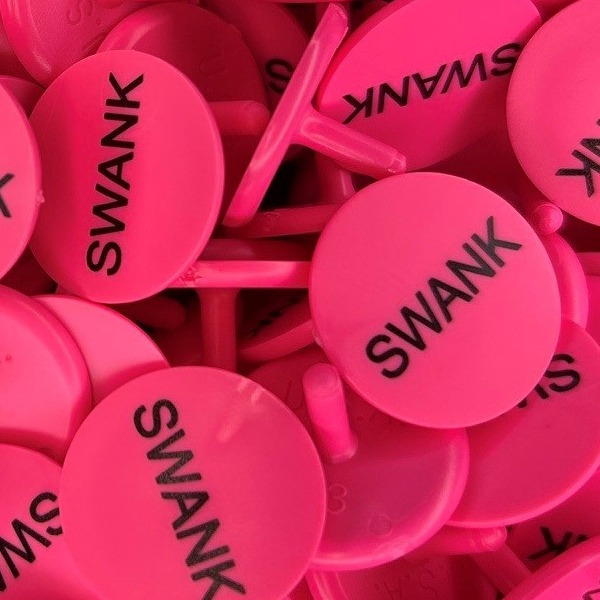 Pink branded golf markers printed with a black company name