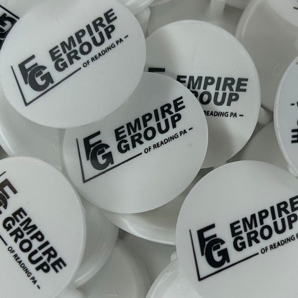 White bulk golf markers printed with a black company logo