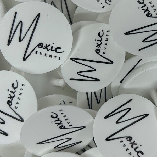 White custom ball markers printed with a black script logo