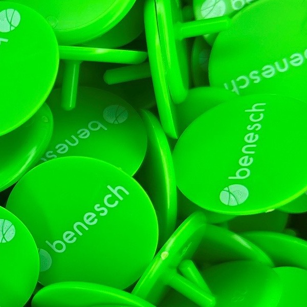 Green personalized golf markers printed with a white company logo