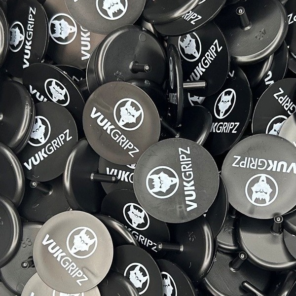 Black and gray custom golf markers printed with a white logo