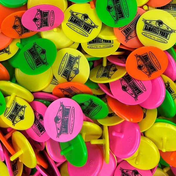 Custom golf markers in assorted bright colors with a black logo