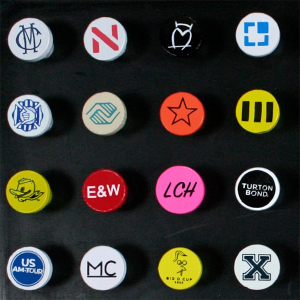 Custom cup-imprinted golf tees featuring colorful business and event logos