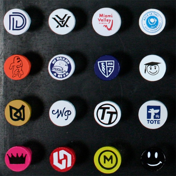 Branded golf tees featuring assorted custom logos printed on the tee cups