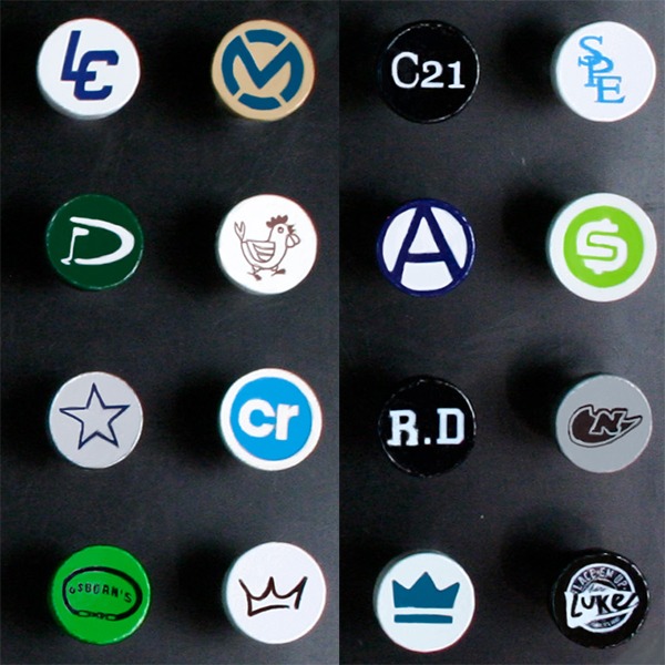 Personalized golf tees with assorted logos and designs printed on the cups