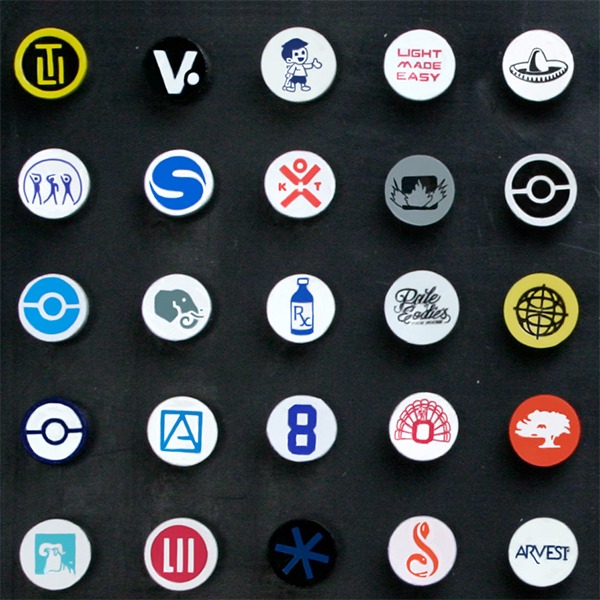 Logo golf tees featuring assorted custom designs printed on the tee cups