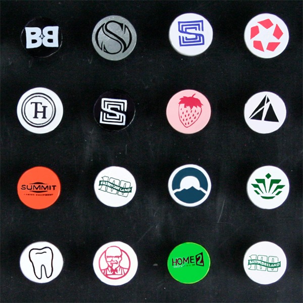 Branded bulk golf tees showcasing assorted custom cup-imprinted logos