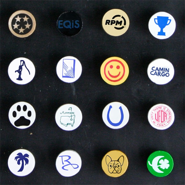 Custom golf tees with assorted colorful logo designs printed on the cups