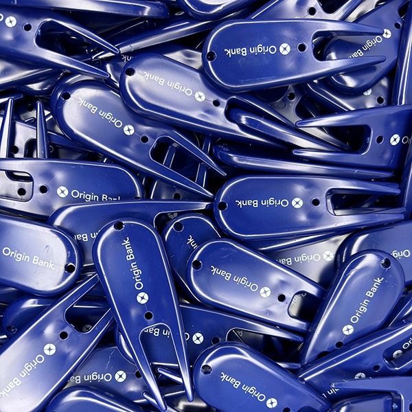 Navy blue personalized divot tools printed with white company branding