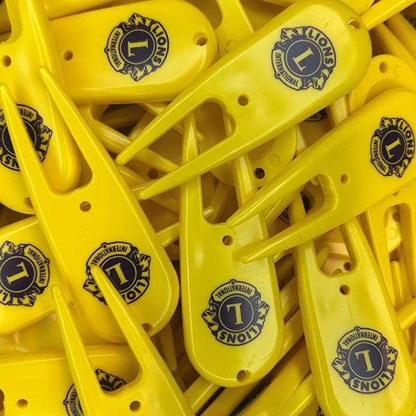 Yellow custom divot tools featuring personalized logo ball markers