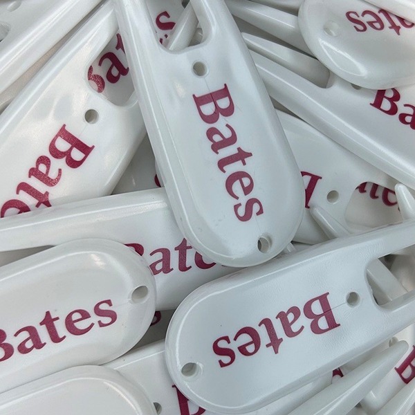 White custom divot repair tools printed with burgundy lettering