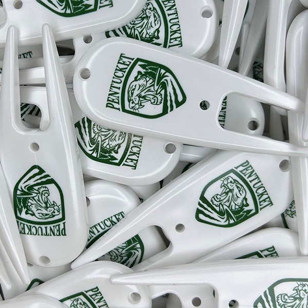White custom divot repair tools printed with green company logos