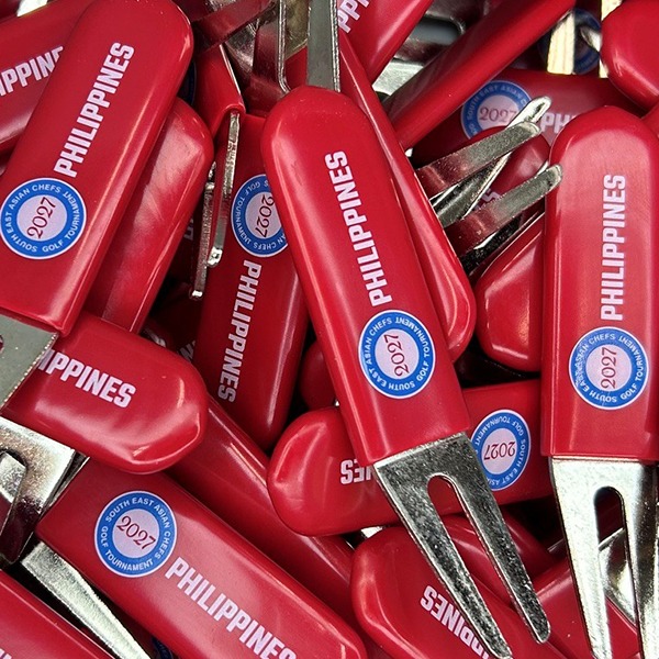 Red Bulk metal divot repair tools printed with company branding 