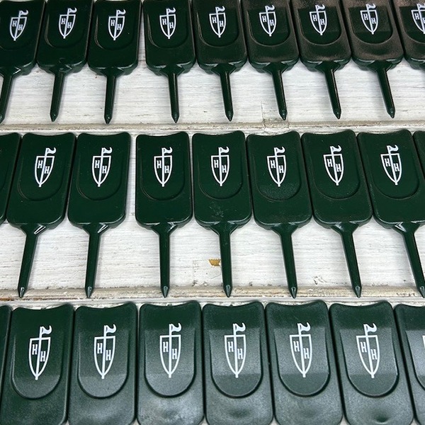 Dark green personalized divot repair tools printed with company logo