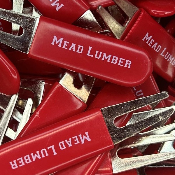 Red personalized metal divot repair tools printed with company branding 