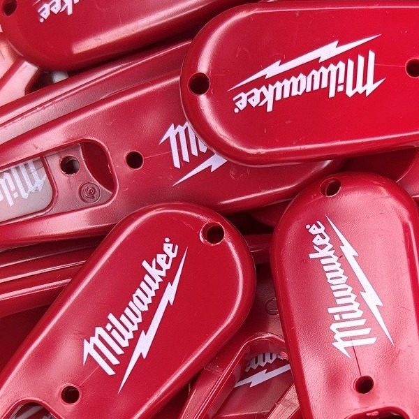 Red personalized divot repair tools printed with company branding 