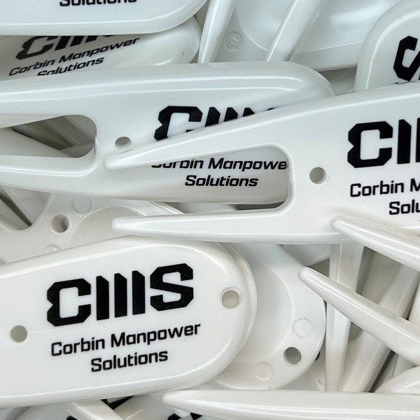 White custom divot repair tools printed with company branding 