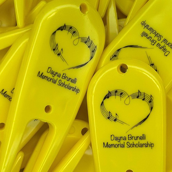Yellow custom divot repair tools printed with a memorial celebration logo