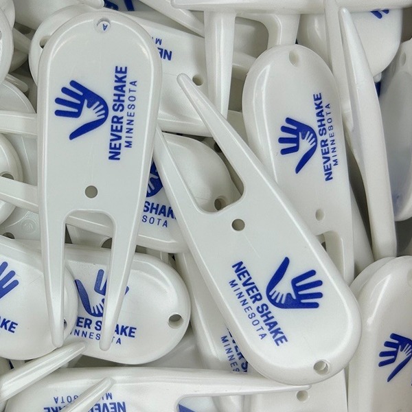 White personalized divot tools printed with a blue hand logo