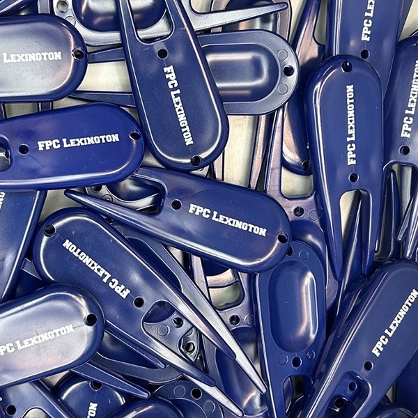 Navy blue custom divot repair tools printed with white logos