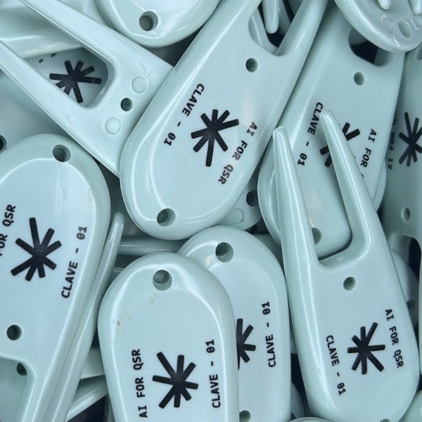 Light blue personalized divot tools featuring black custom logo designs