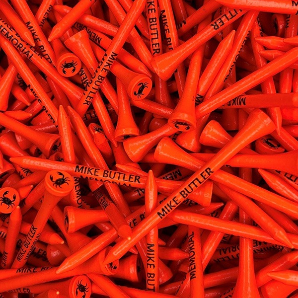 Red personalized golf tees printed with black custom lettering