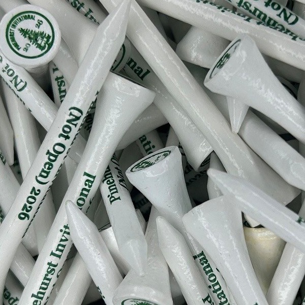 White custom logo golf tees printed with green company branding