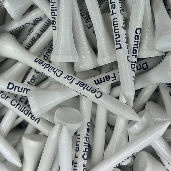 White custom golf tees printed with a navy charity name