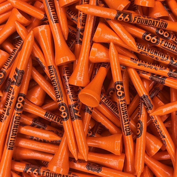Orange branded golf tees printed with a black foundation logo