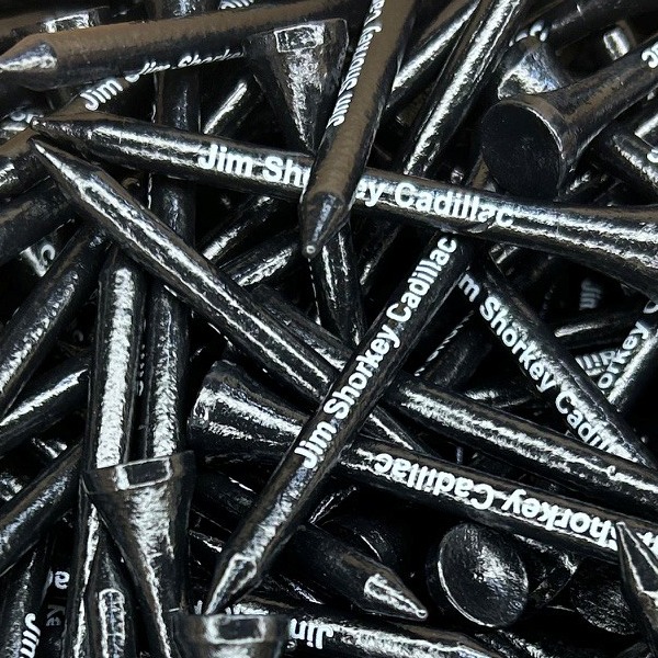 Black branded golf tees printed with a white dealership name