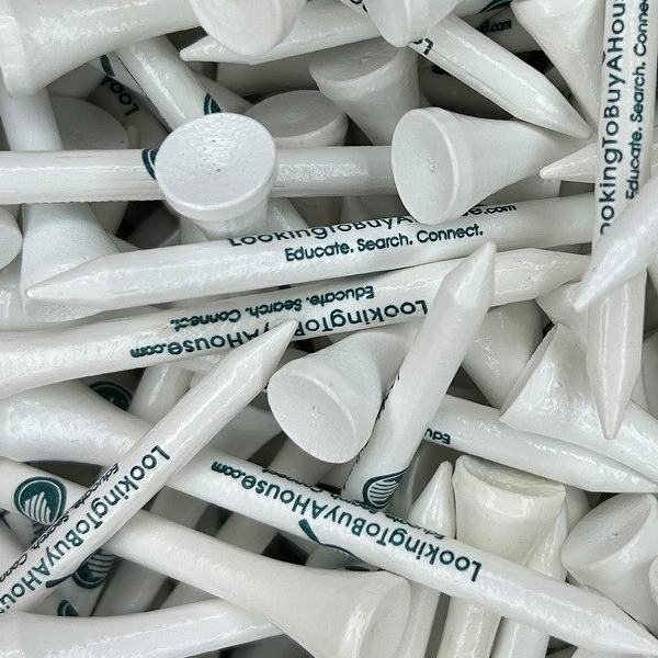 White personalized golf tees printed with a green website name
