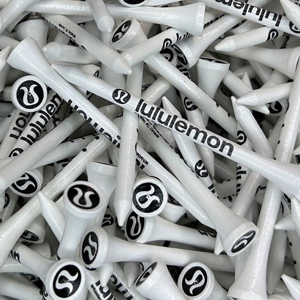 White logo golf tees featuring black custom branding on the stems and cups