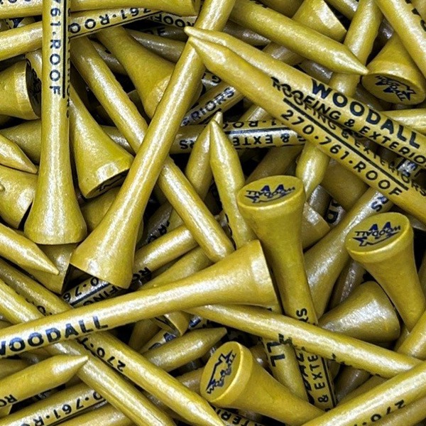 Gold wholesale golf tees printed with black custom logos and lettering