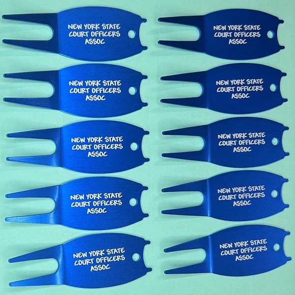 Blue aluminum divot tools personalized for a golf tournament