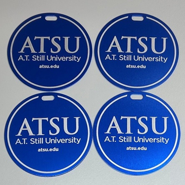 Round blue personalized golf bag tags with a university logo
