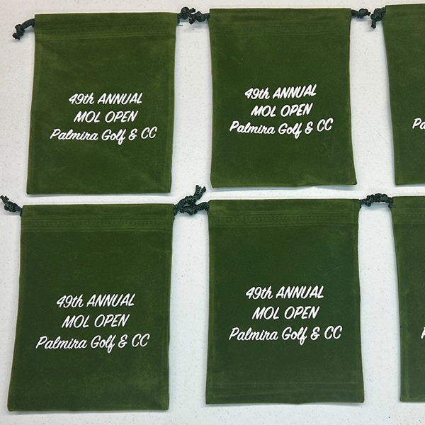 Green drawstring bags printed for an annual golf tournament
