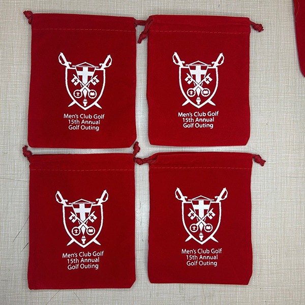 Red drawstring bags with a custom crest for a golf outing