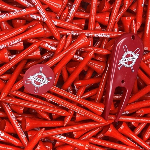 Red custom golf tees with a logo divot tool and ball marker