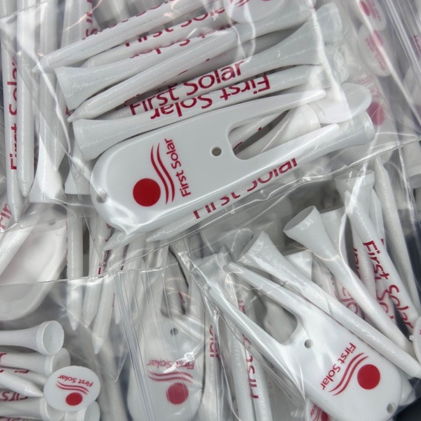 Imprinted golf items with white tees and divot tools in packs