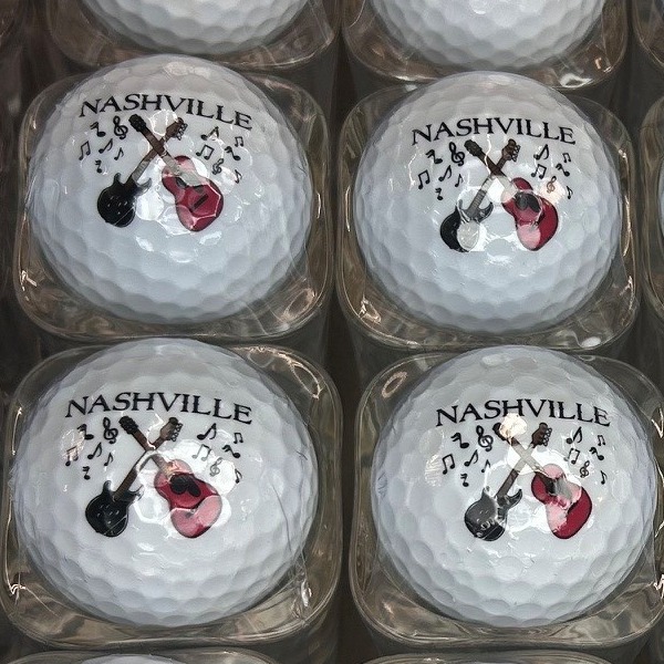 Custom golf balls displayed in shot glasses for an event