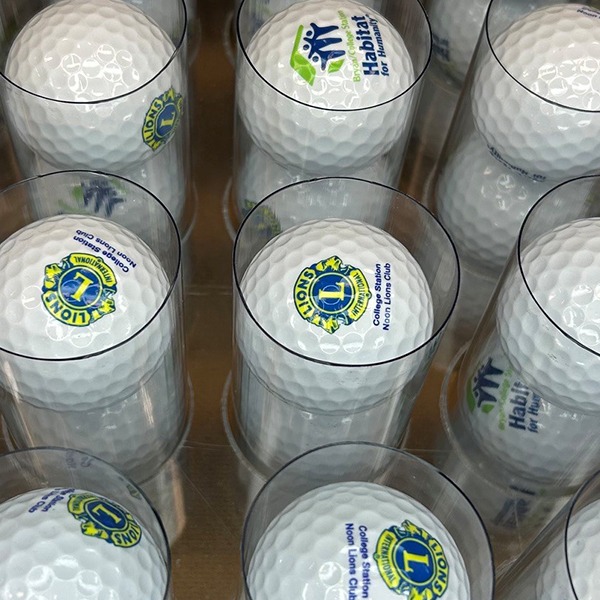 Logo golf balls packaged in clear plastic tubes