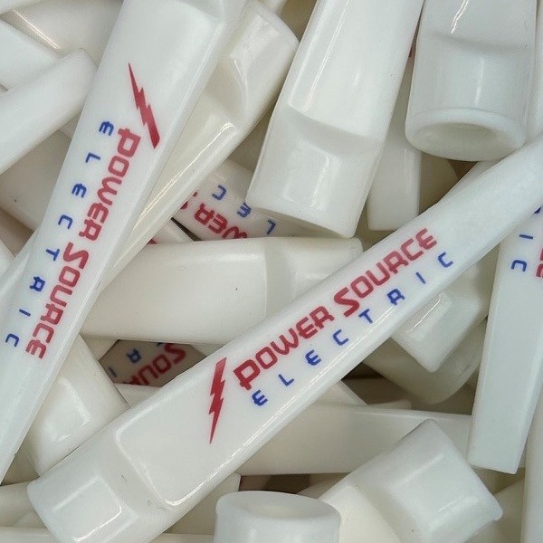 White plastic wedge tees printed with a company logo