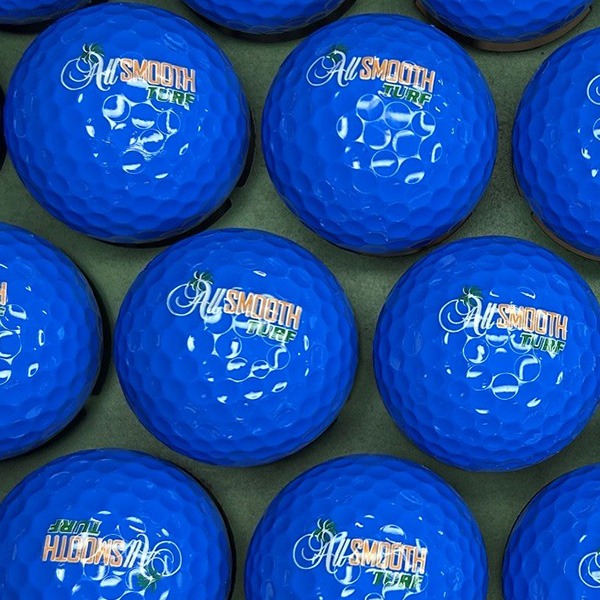 Blue custom golf balls printed with a white logo